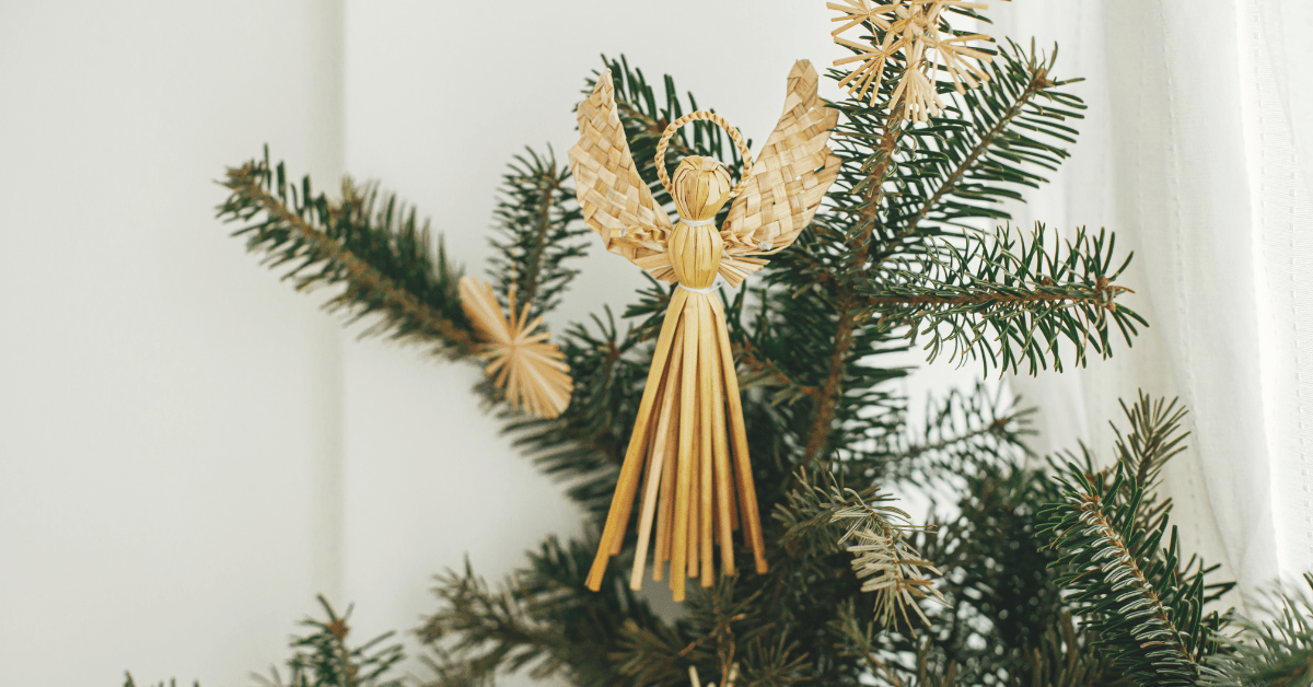 Angle made of straw on Christmas tree.