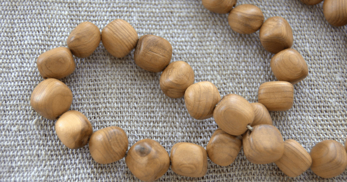 Wooden beads on fabric.