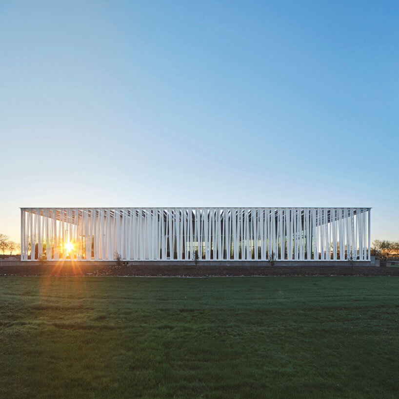 perforated metallic canopy filters light within richärd kennedy architects' asante public library