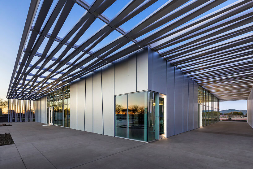 perforated metallic canopy filters light within richärd kennedy architects' asante public library