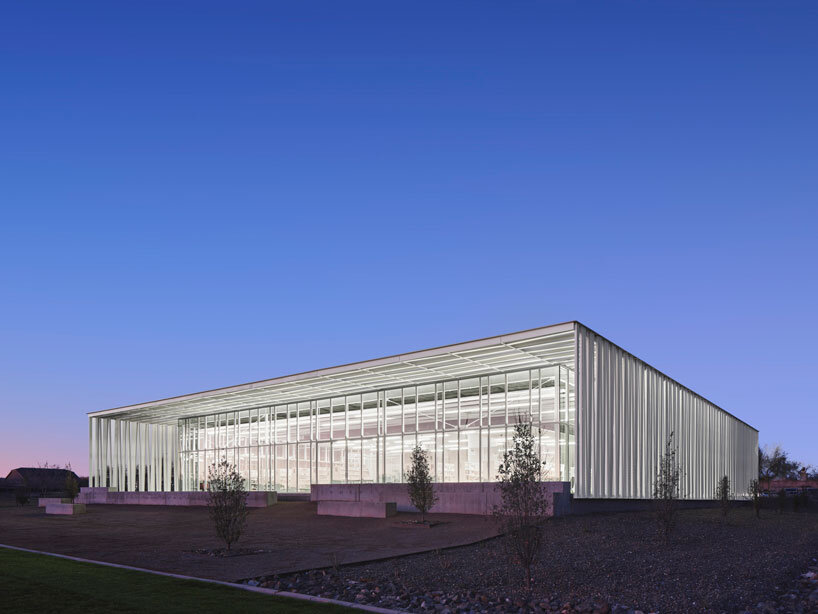 perforated metallic canopy filters light within richärd kennedy architects' asante public library