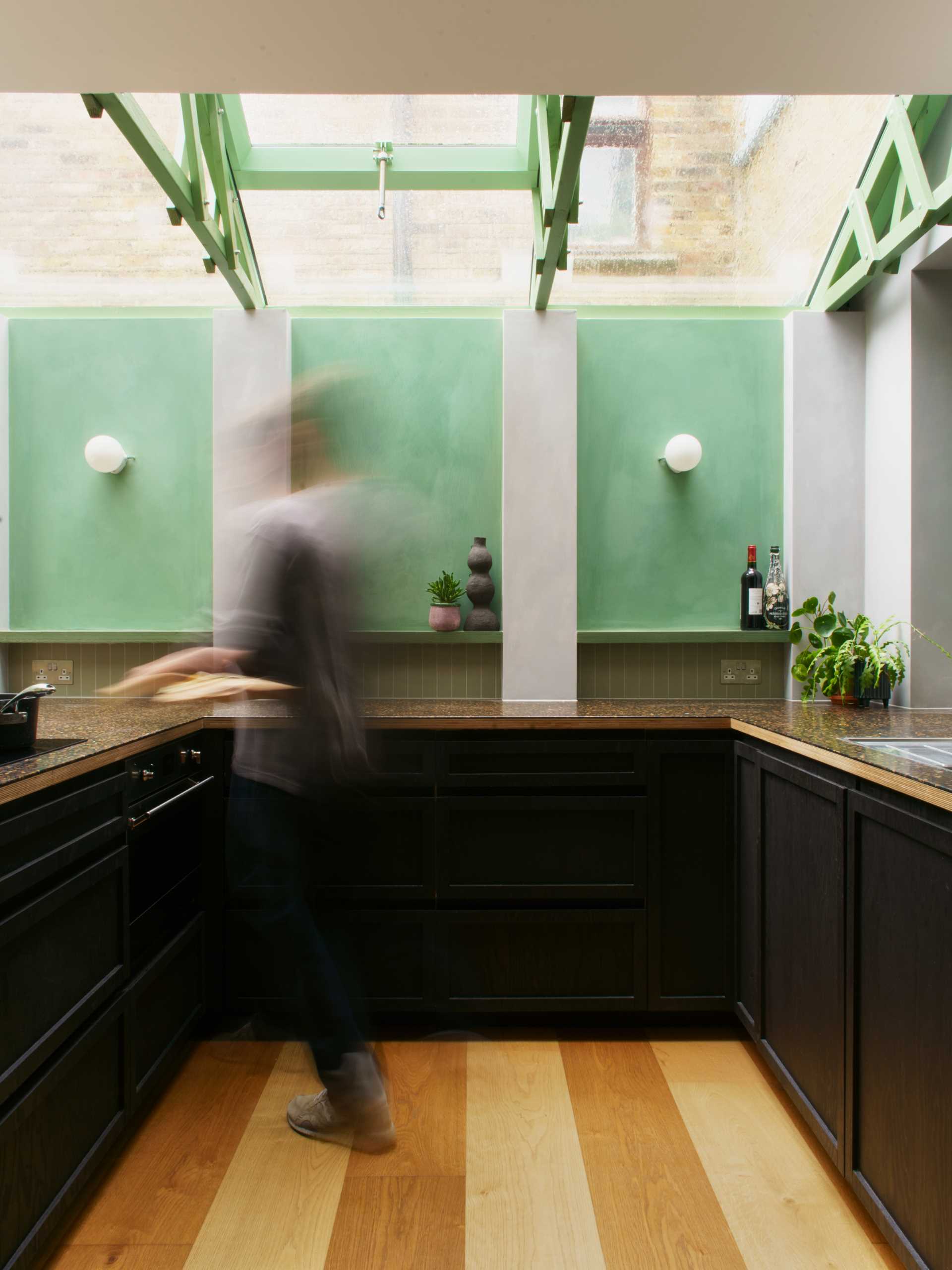 A modern home extension with a curved window, a skylight, and a new dining area and custom kitchen with IKEA cabinets.