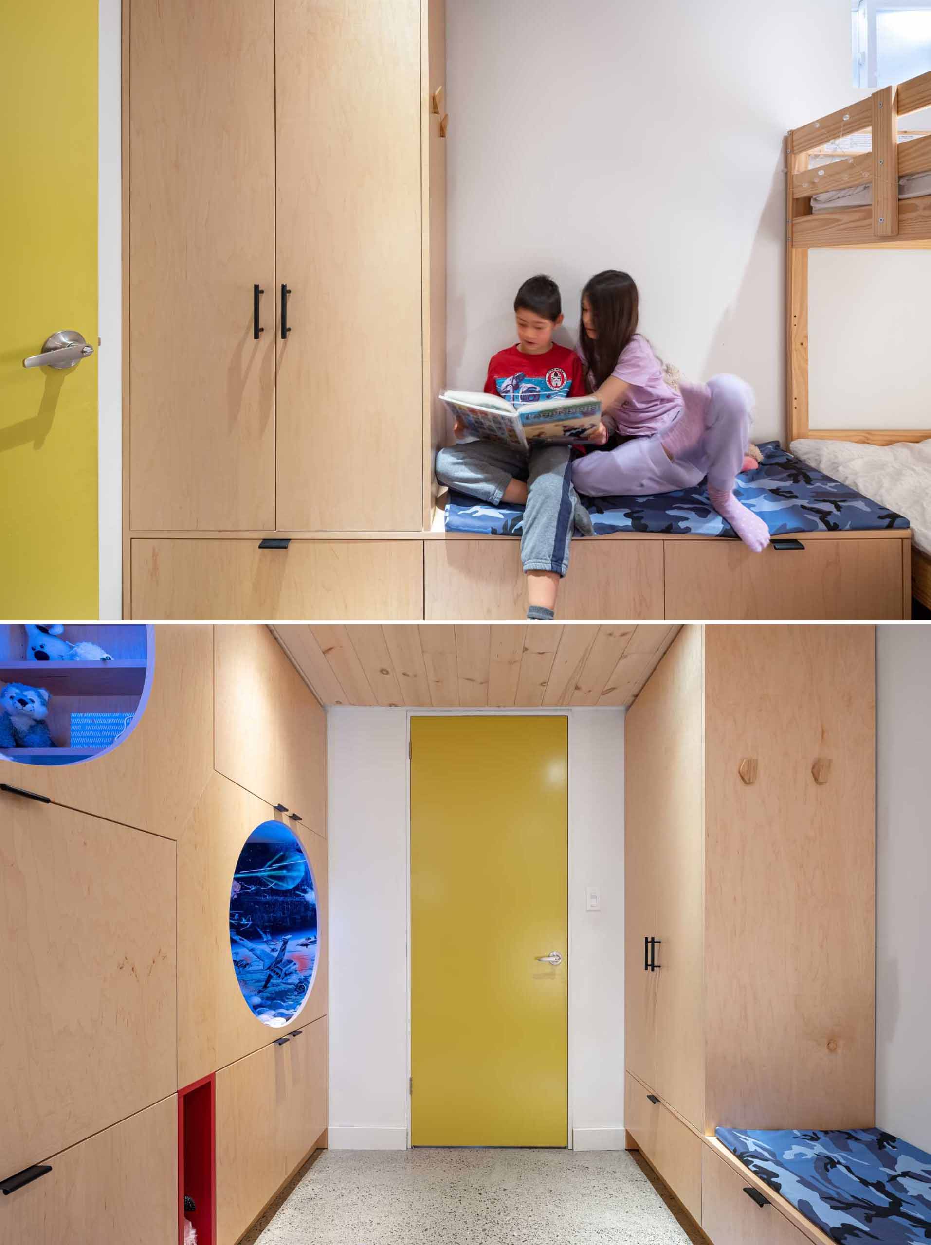 A kids bedroom with built-in storage in the form of cabinets and benches, as well as bunk beds, and two reading nooks.