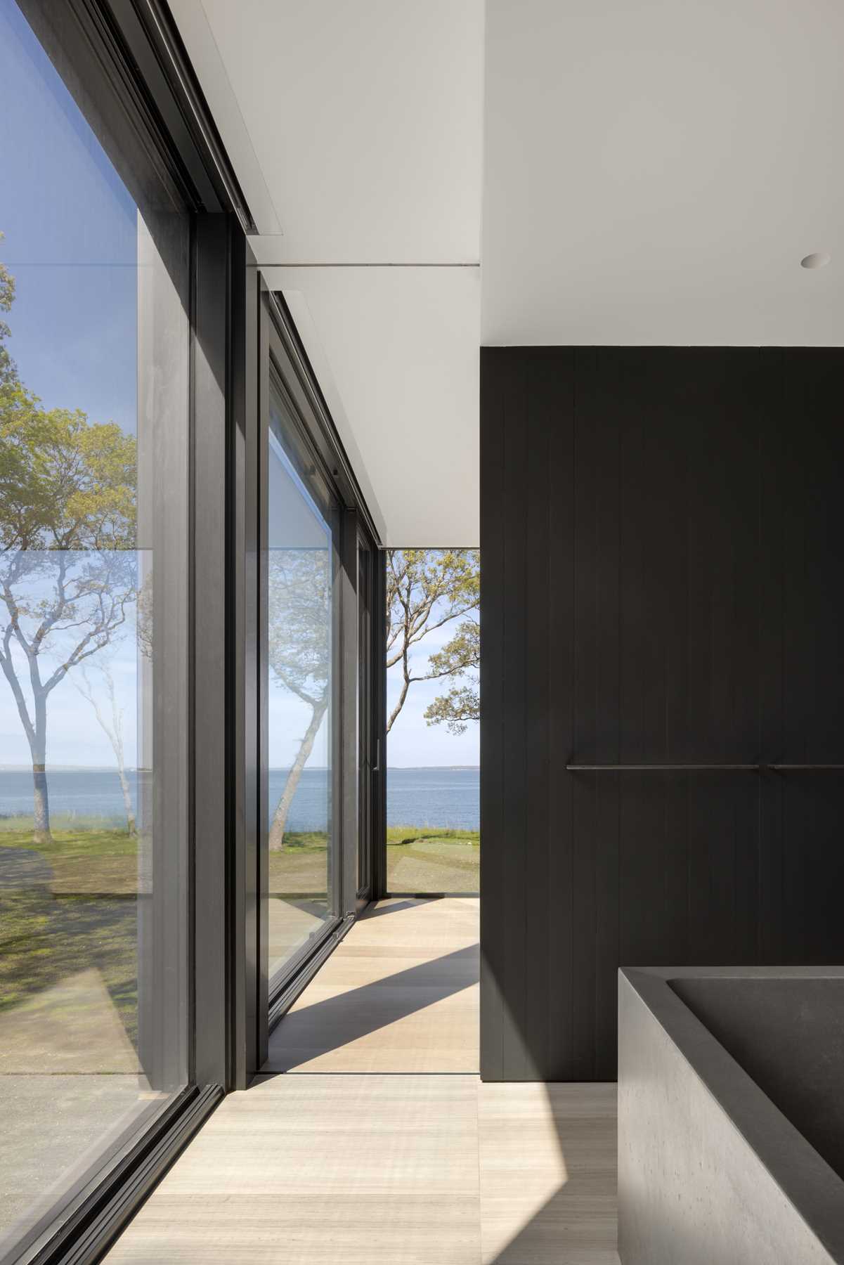 In the bathroom, a sculptural, custom concrete floating tub is placed in the center of the bathroom, while a steam shower is available behind.