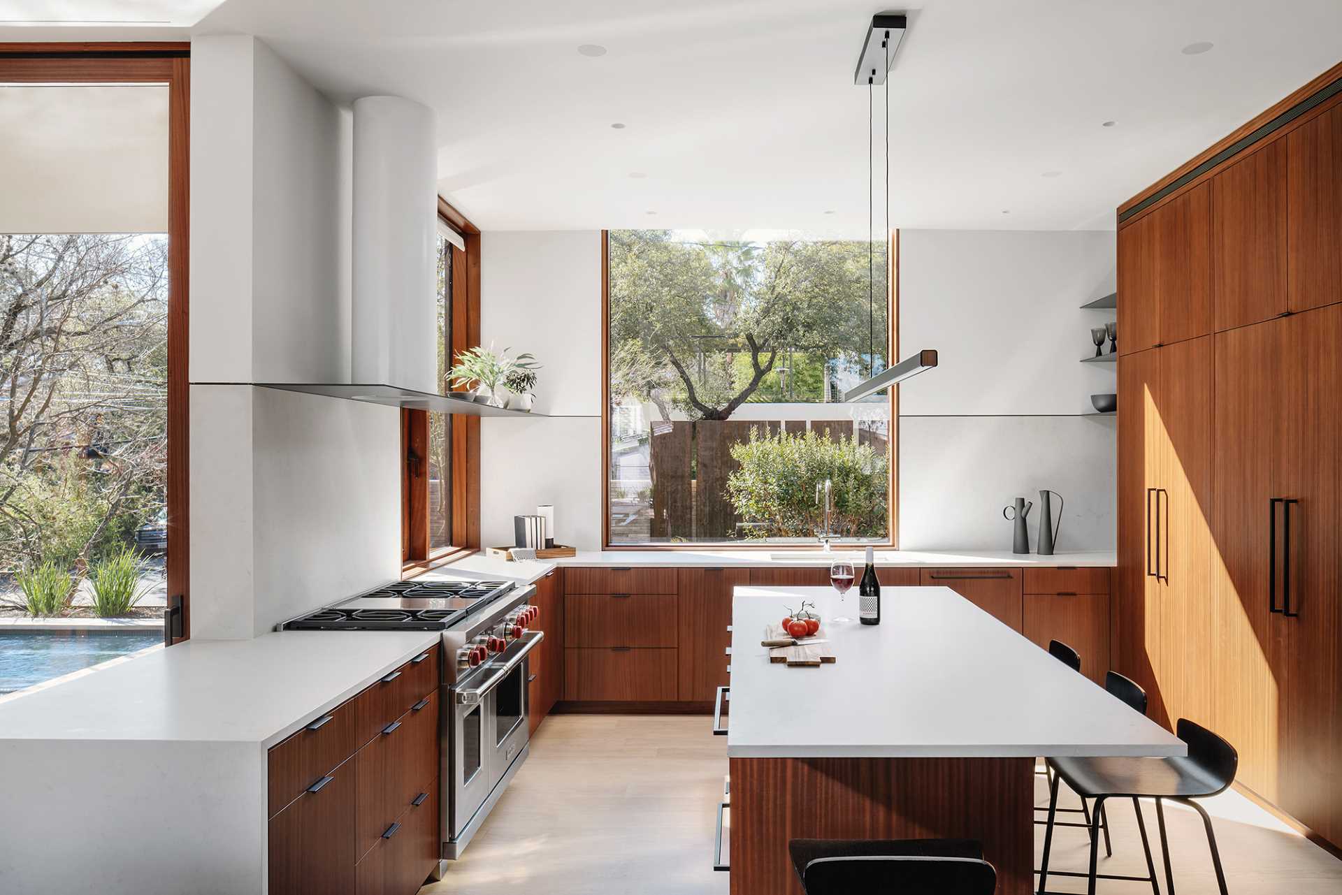 In the kitchen, wood cabinets complement the wood window and door frames, while a central island creates additional counter space.