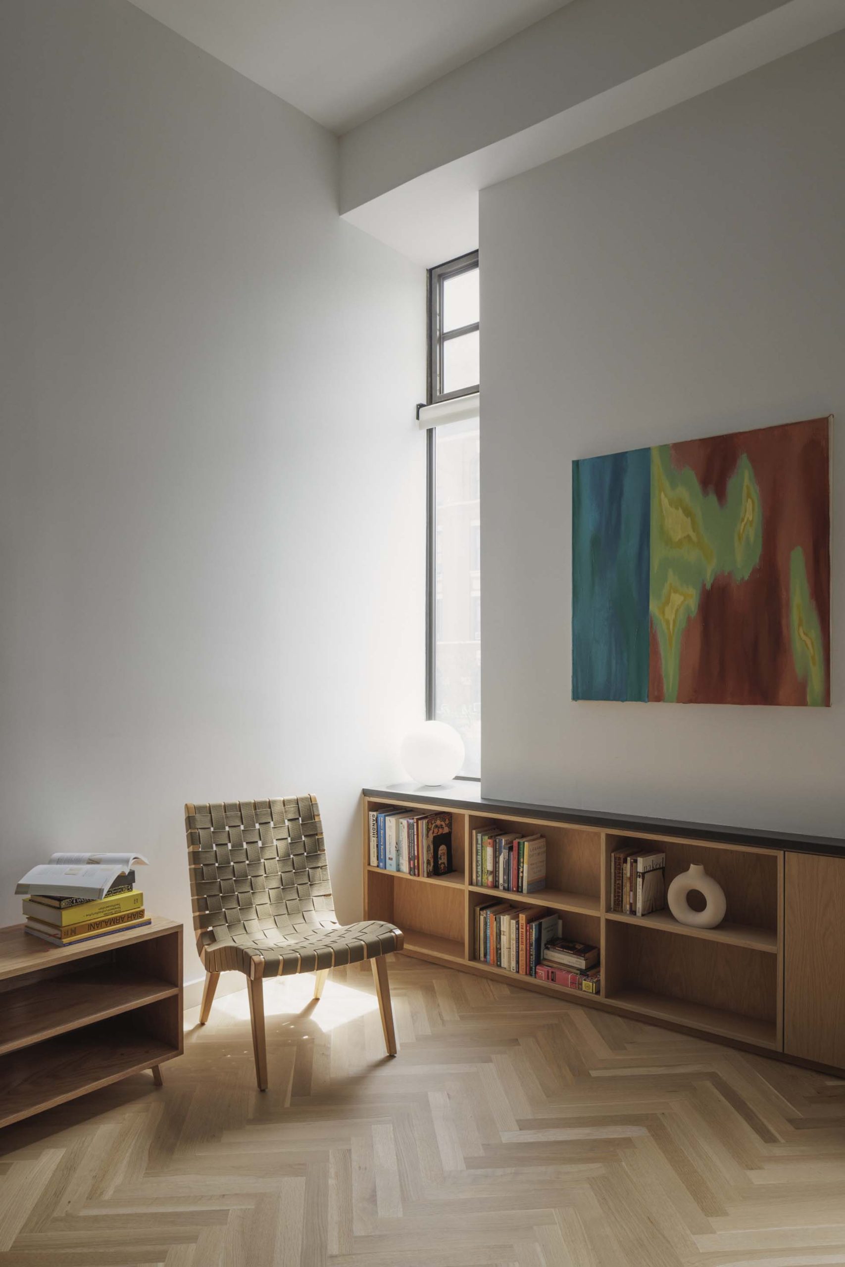 The view from the kitchen to the living room shows the built-in open cabinetry that the wall.