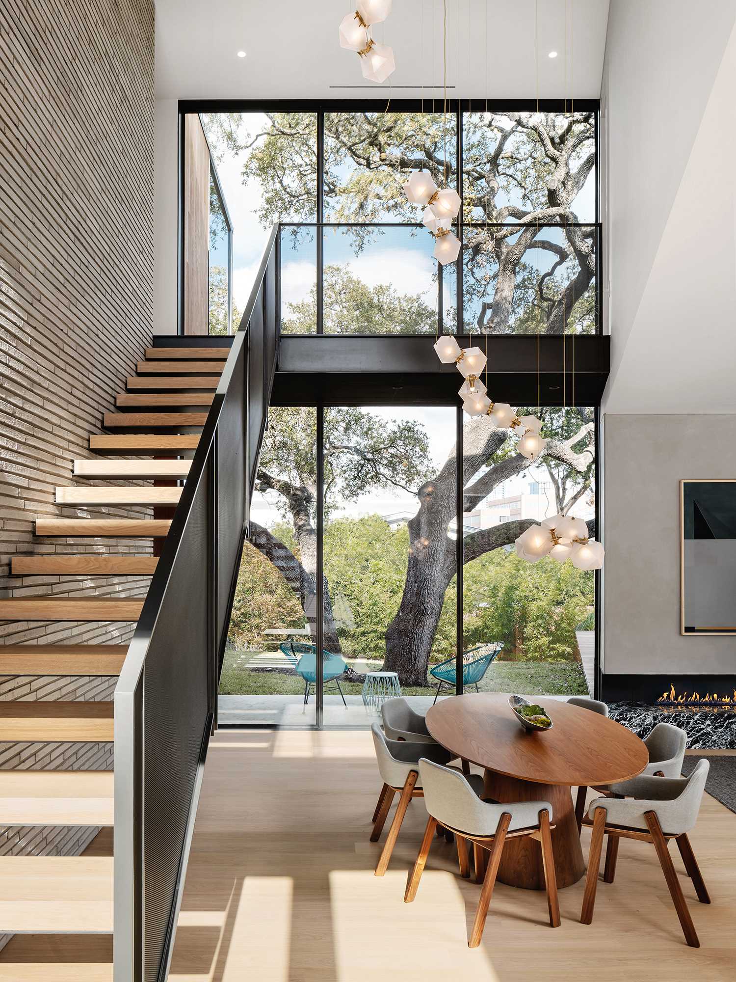 Steel stairs with wood treads lead from the social areas of the home up to the more private spaces.