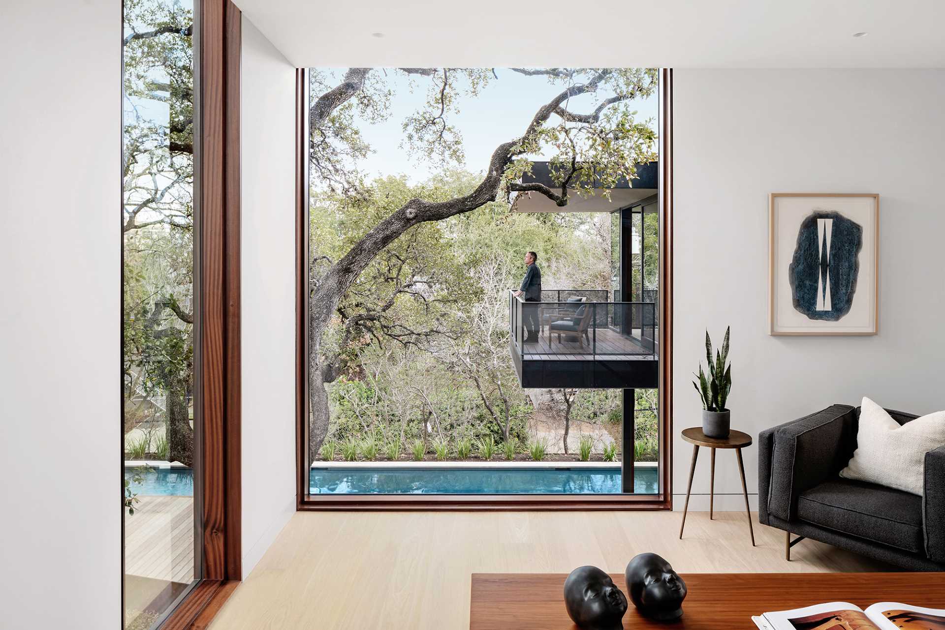 A modern living room with large windows that flood the interior with natural light.